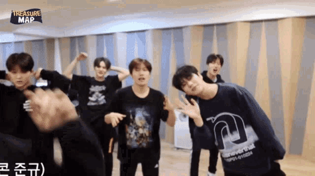 a group of young men are dancing in a room that says treasure map on the bottom