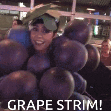 a woman is dressed as a bunch of grapes and says grape trim