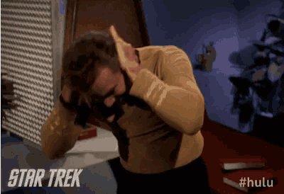 a man covering his ears with his hands in a star trek advertisement