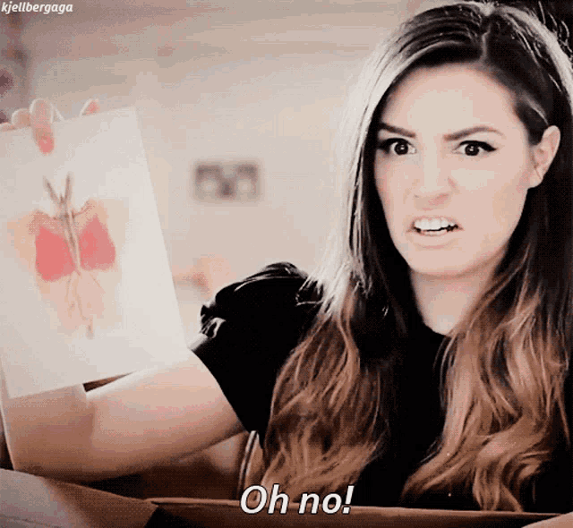 a woman is holding a piece of paper and says oh no