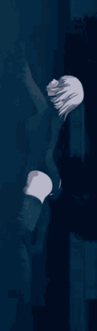 a man with white hair is standing in the dark in a dark room .