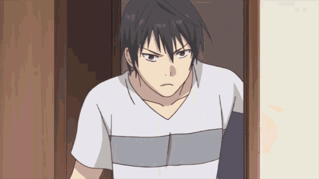 a man with a striped shirt is standing in a room