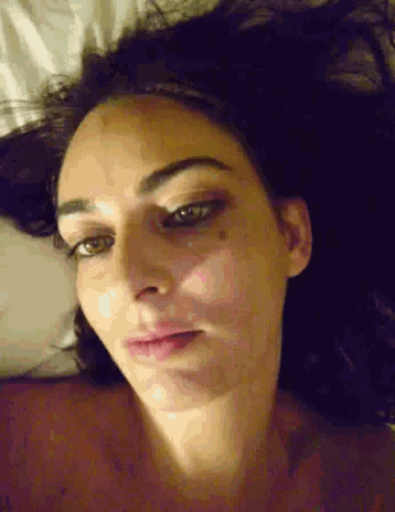 a close up of a woman 's face with a tattoo on her forehead