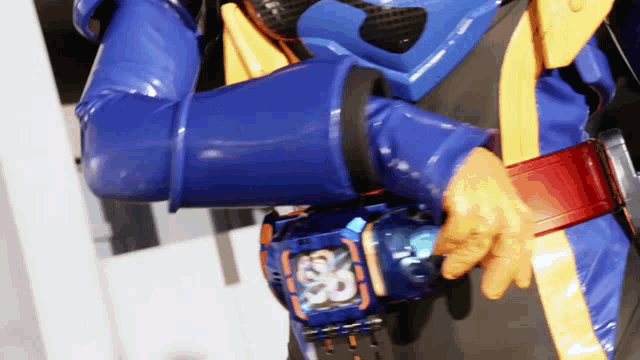 a person wearing a blue and yellow costume with a belt that says ' ss ' on it
