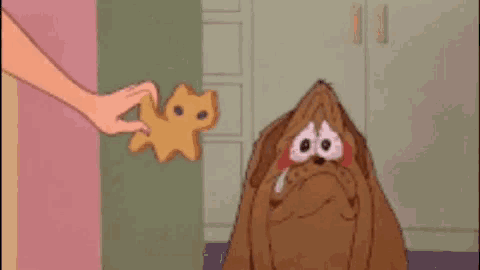 a cartoon of a dog being given a cookie by a person