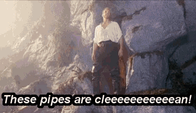a man is standing on a rock with the words " these pipes are cleeeeeeeean " written below him