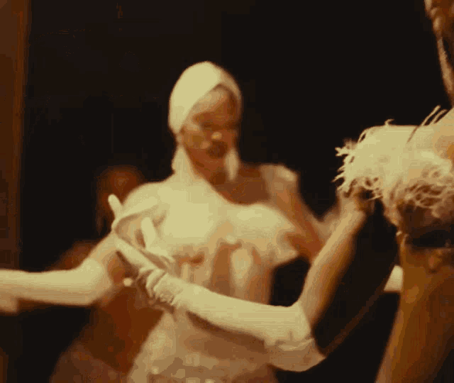 two women in white gloves are dancing together