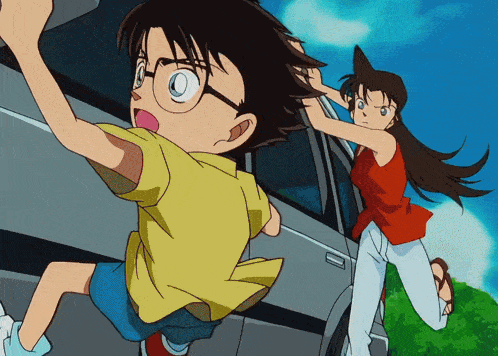 a boy in a yellow shirt is being pulled out of a car by a woman in a red shirt