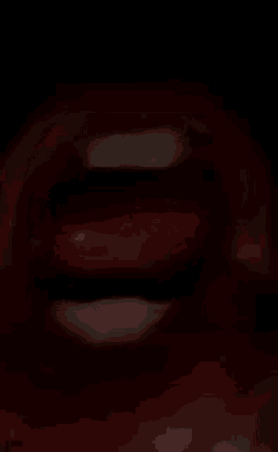 a close up of a woman 's mouth with her tongue out .