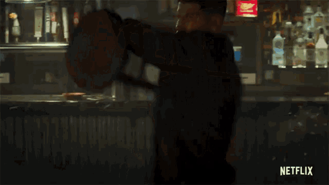 a man with blood on his face is in a bar with a netflix logo on the bottom