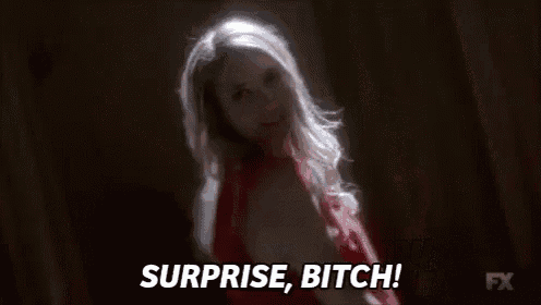 a woman in a red dress is saying surprise , bitch !