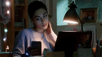 a woman is sitting at a desk using a laptop computer .