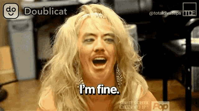 a woman with blonde hair and a fake mustache says i 'm fine