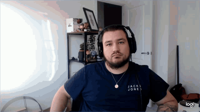 a man wearing headphones and a shirt that says jack & jones
