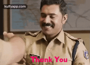 a police officer is smiling and giving a thumbs up to a person .