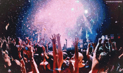 a crowd of people with their hands in the air with volersouvenirs written on the bottom