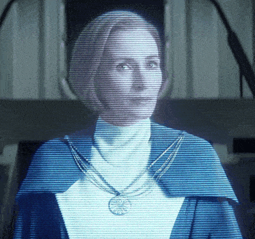 a woman 's face is projected on a screen with a necklace around her neck