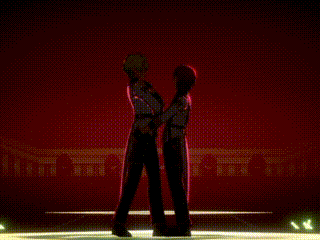 a couple of anime characters are standing next to each other in front of a red background .