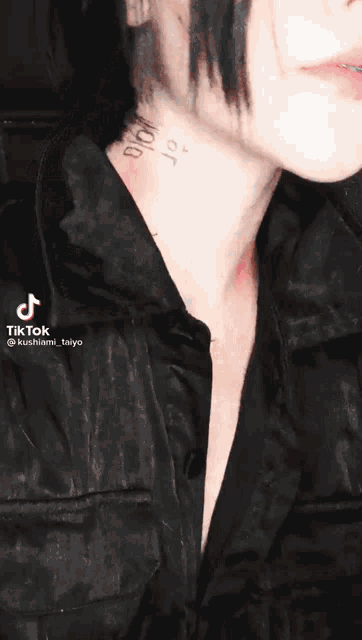 a close up of a person 's neck with a tattoo that says " bitch " on it