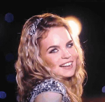 a close up of a woman 's face with a headband on her hair