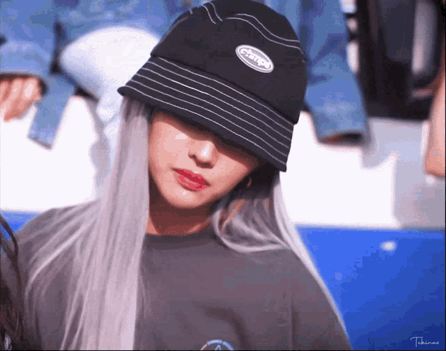 a woman wearing a black bucket hat with the word change on it