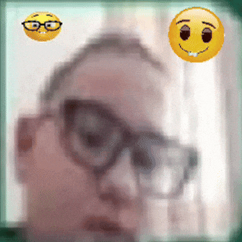 a blurry picture of a man wearing glasses with a smiley face behind him
