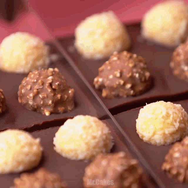 a close up of chocolate covered balls with the words mr.cakes below them