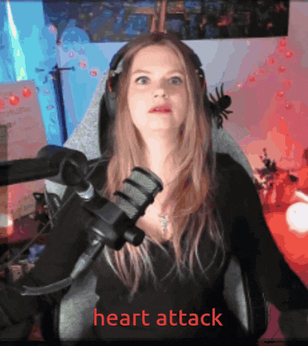 a woman is sitting in front of a microphone with the words heart attack written on the bottom