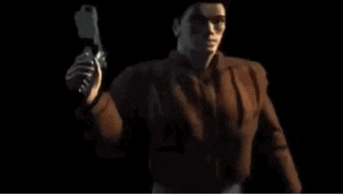 a man is holding a gun in a dark room