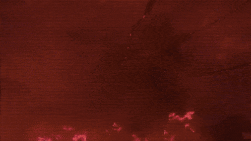 a silhouette of a person in a dark room with red lights behind them