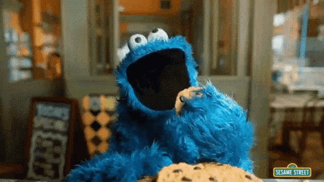 a cookie monster from sesame street eating a cookie