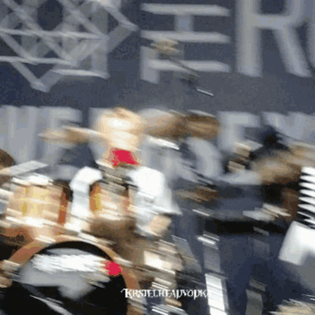 a blurry photo of a group of people with the name kirsten on the bottom left corner