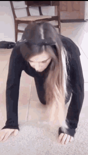 a woman is crawling on the floor wearing a cat costume