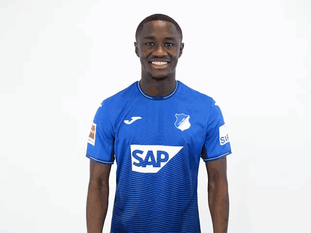a man wearing a blue shirt with sap on it