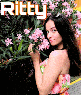 a woman smelling flowers with the name ritty above her