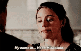 a woman is talking to a man and saying `` my name is ... hope mikaelson '' .