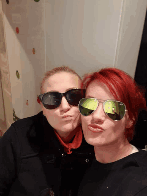 two women wearing sunglasses and making funny faces