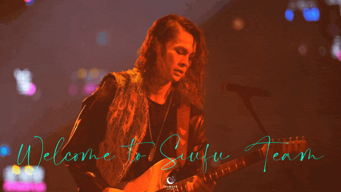 a man playing a guitar and singing into a microphone with the words welcome to sufu team behind him