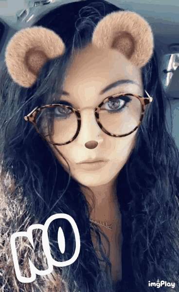 a woman wearing glasses and bear ears has the word no written on her face