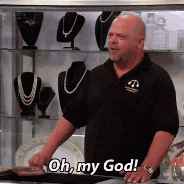 a bald man in a black shirt is standing in front of a display case and says oh my god