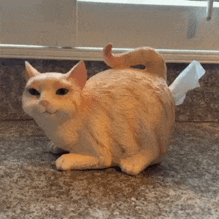 a statue of a cat on a counter top