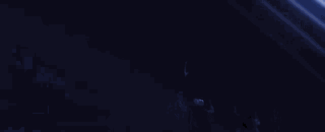 a silhouette of two people standing in front of a blue background .