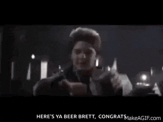 a young boy is holding a glass of beer and says here 's ya beer brett congrats makeagif.com
