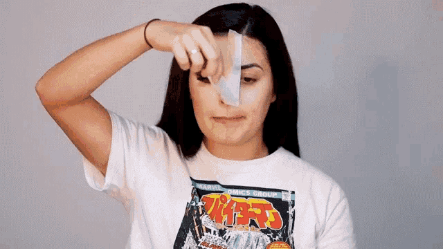 a woman wearing a white t-shirt with a marvel comic book cover on it