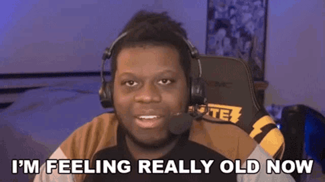 a man wearing headphones and a microphone is saying `` i 'm feeling really old now ''