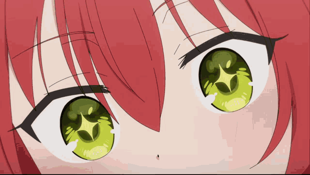 a close up of a girl 's green eyes with a star in them