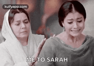 two women are standing next to each other and one is crying while the other is comforting her .
