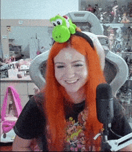 a woman with red hair wearing a headband with a stuffed animal on it