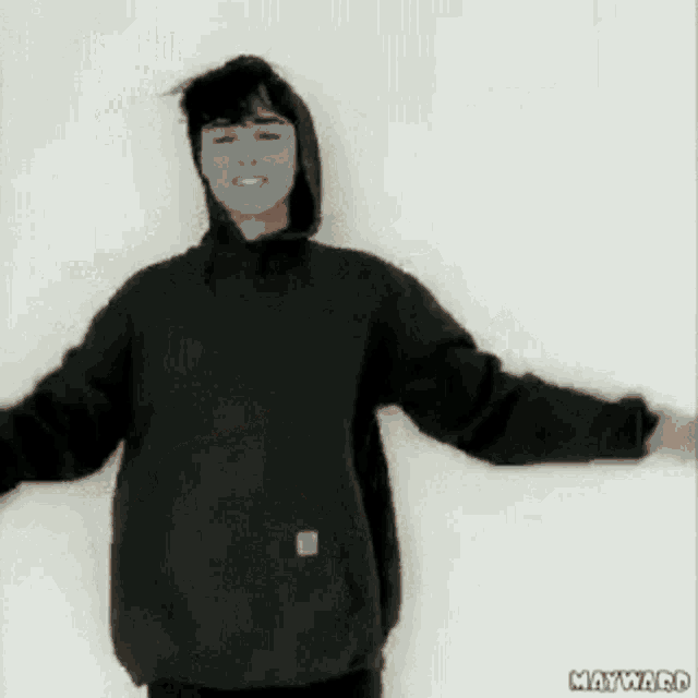 a man wearing a black shirt with a german flag on the back is dancing