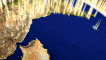 an aerial view of the earth with a few buildings in the distance